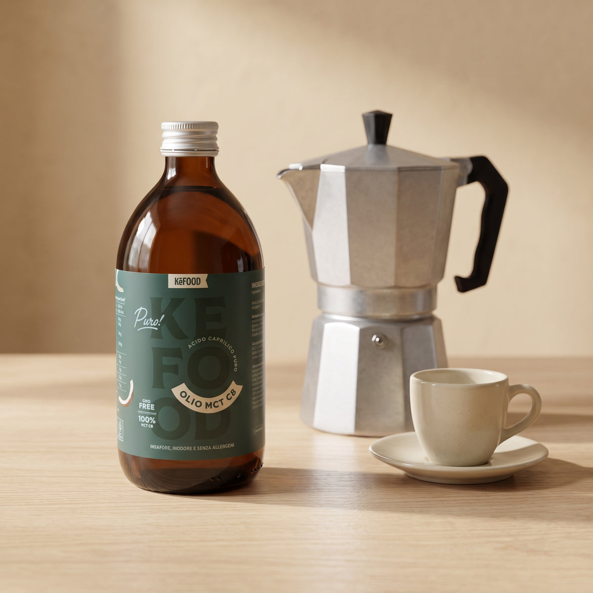 Olio MCT C8 Kefood da 500 ml accanto a una moka e a una tazzina, per capire le dimensioni della bottiglia